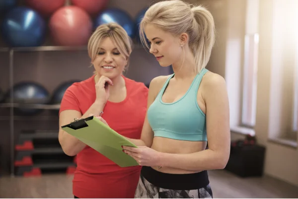 Trainer giving a free body Comp assessment to woman