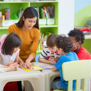 Childcare provider reading to children