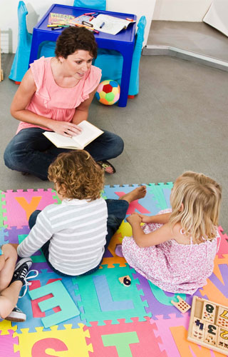 Child care provider reading to children