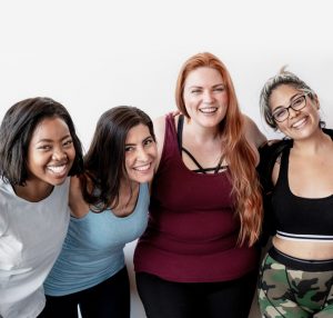 A group of women in the gym smiling