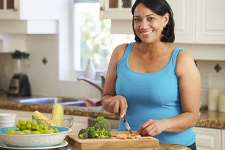 woman cutting veg on cutting board