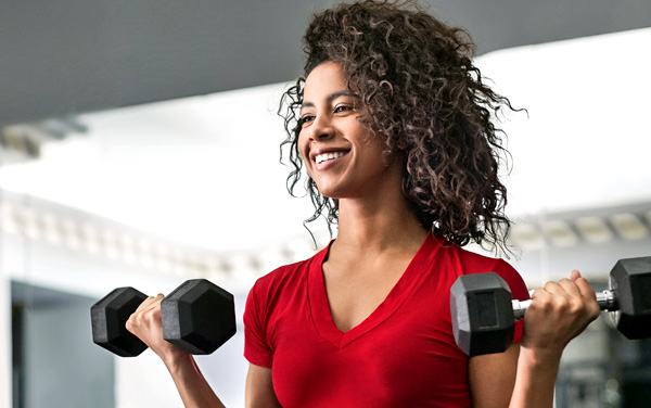 healthy fit young woman lifting weights